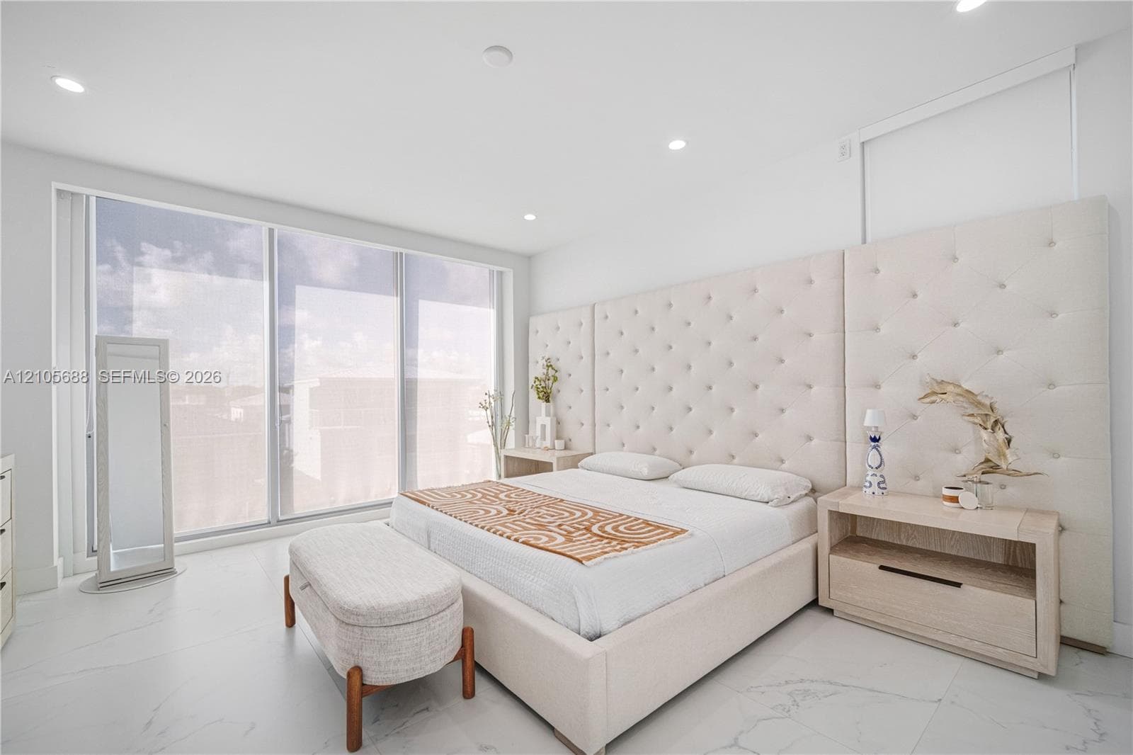 Master. Floor-to-ceiling windows, recessed lighting, and large-format tile flooring