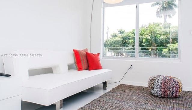 Large dual-pane sliding window with aluminum framing and mature exterior greenery