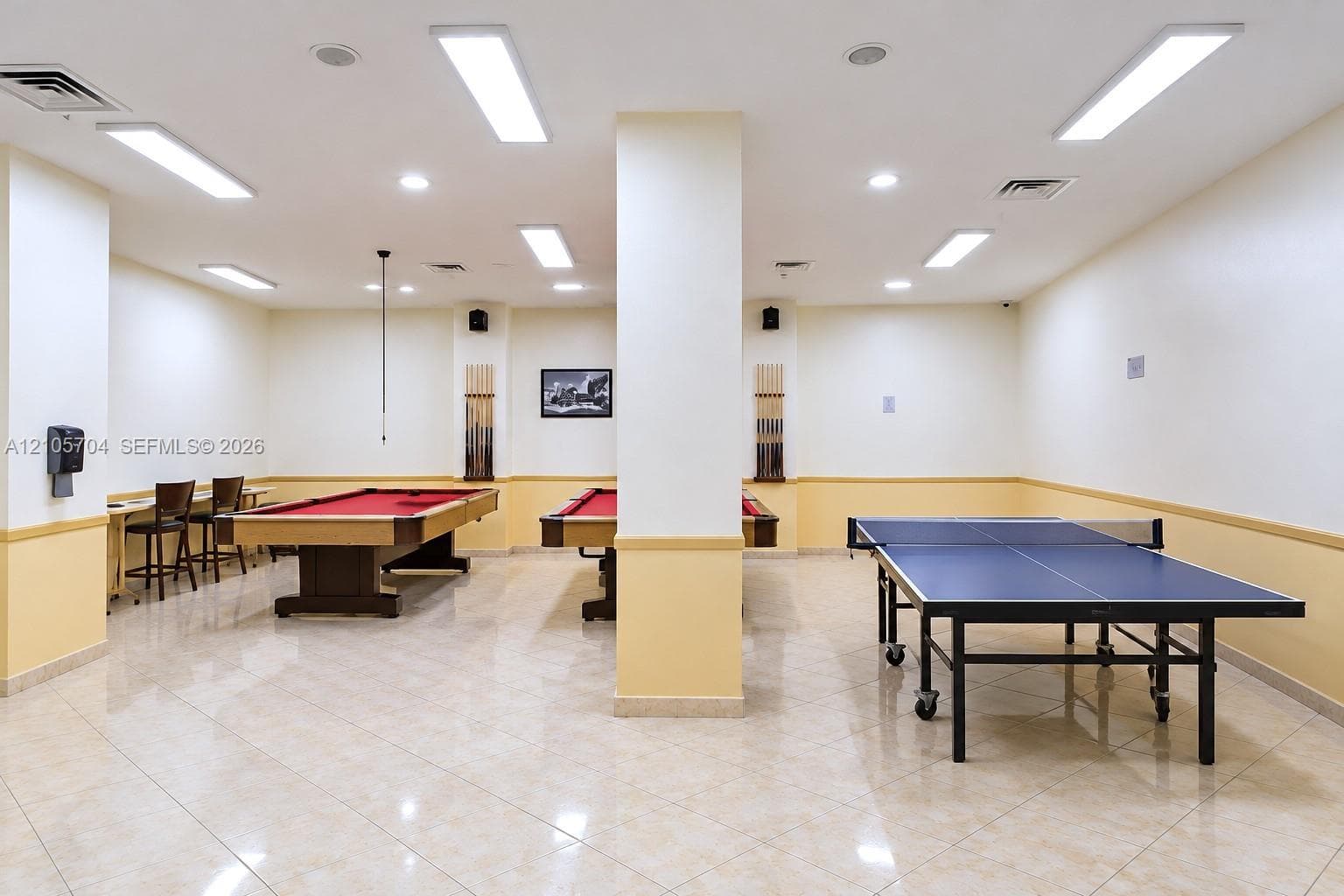Spacious interior room featuring tile flooring, recessed lighting, and a neutral two-tone wall finish
