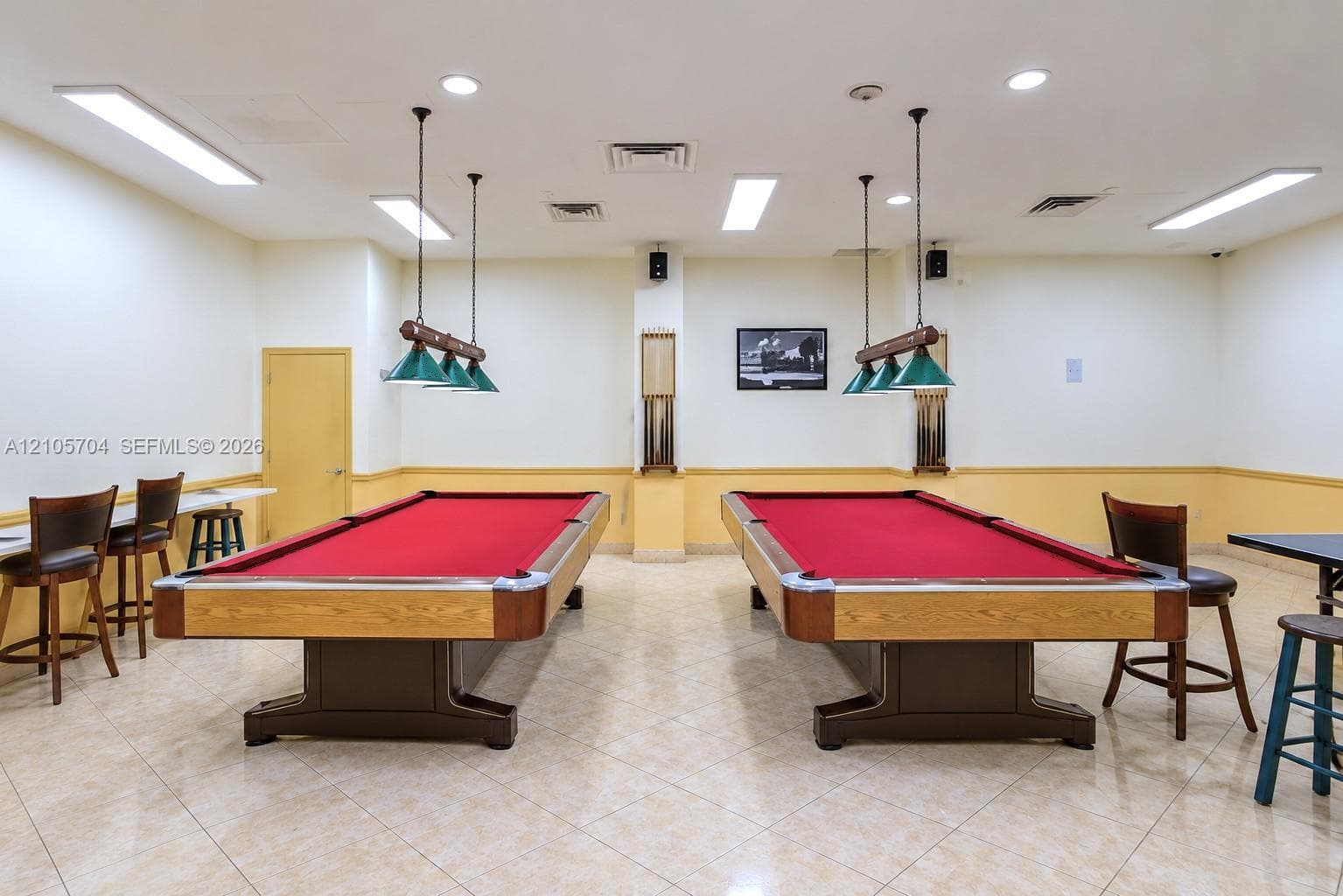 Recreational space featuring tile flooring, recessed lighting, and wall-mounted task lights