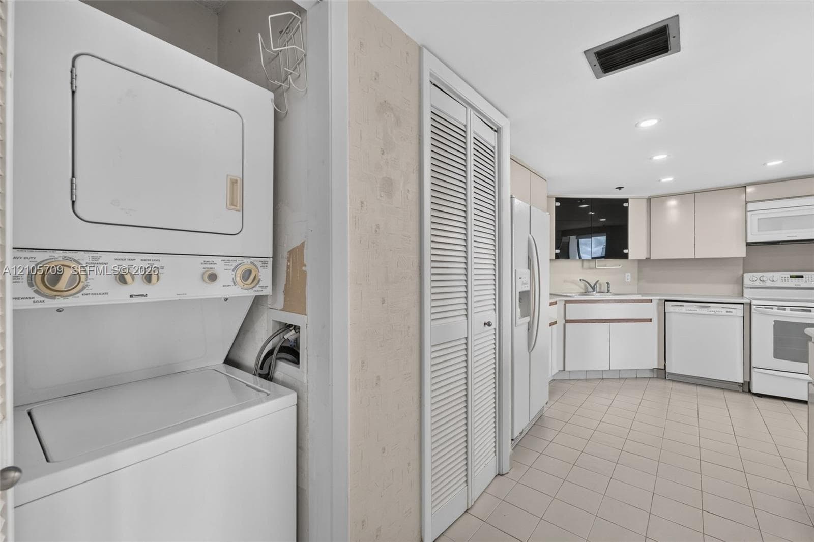 Finished flex space featuring a patterned carpet floor, neutral wall paint, and a drop ceiling with recessed lighting