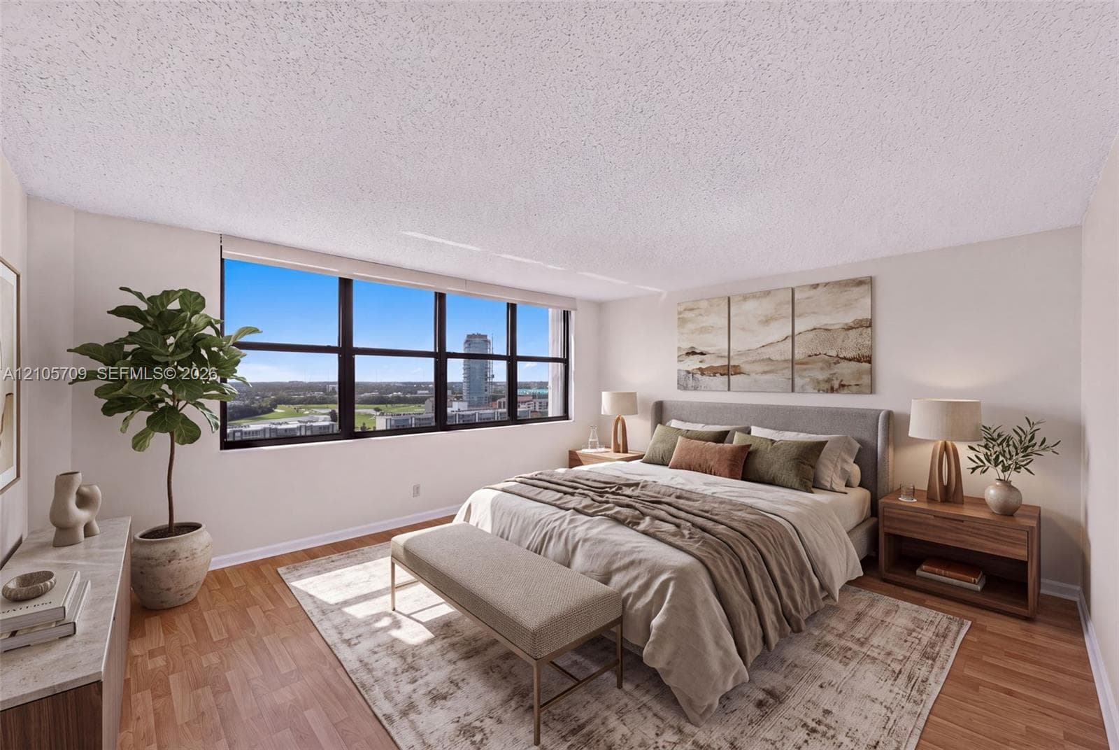 High-rise residential building featuring private balconies, dual tennis courts, an outdoor swimming pool, and dedicated parking