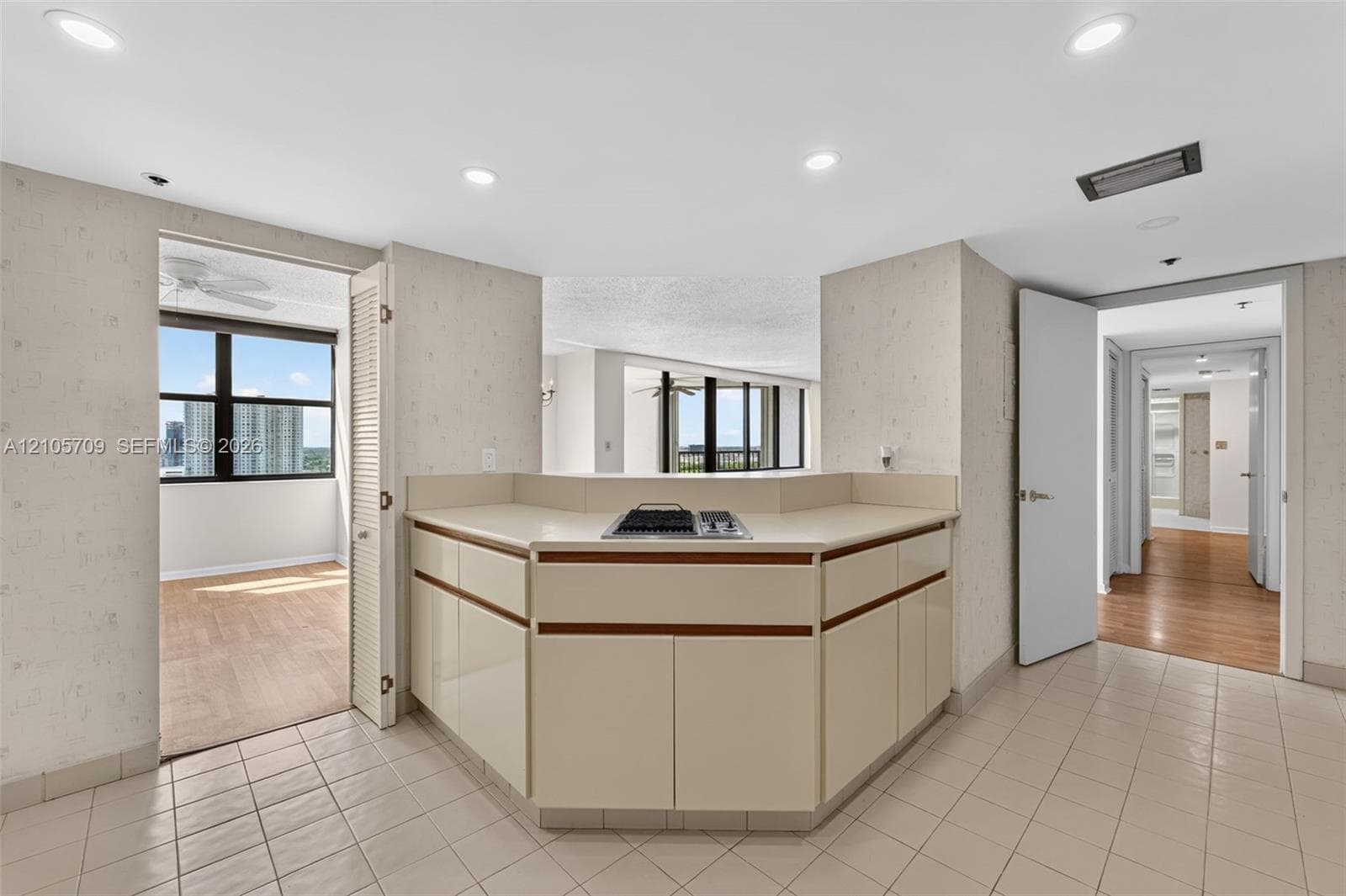 Fitness facility featuring rubberized flooring, expansive floor-to-ceiling windows, and recessed panel lighting