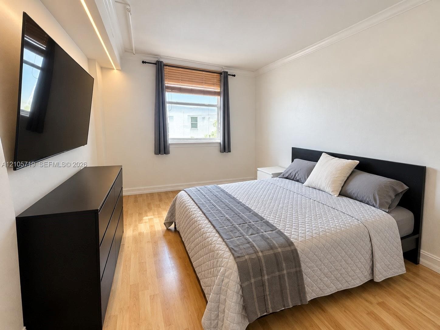 Wood-finish flooring, crown molding, and recessed ceiling lighting