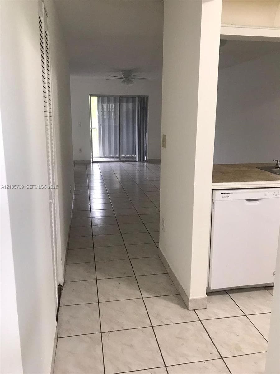 Ceramic tile flooring, built-in dishwasher, and sliding glass patio doors