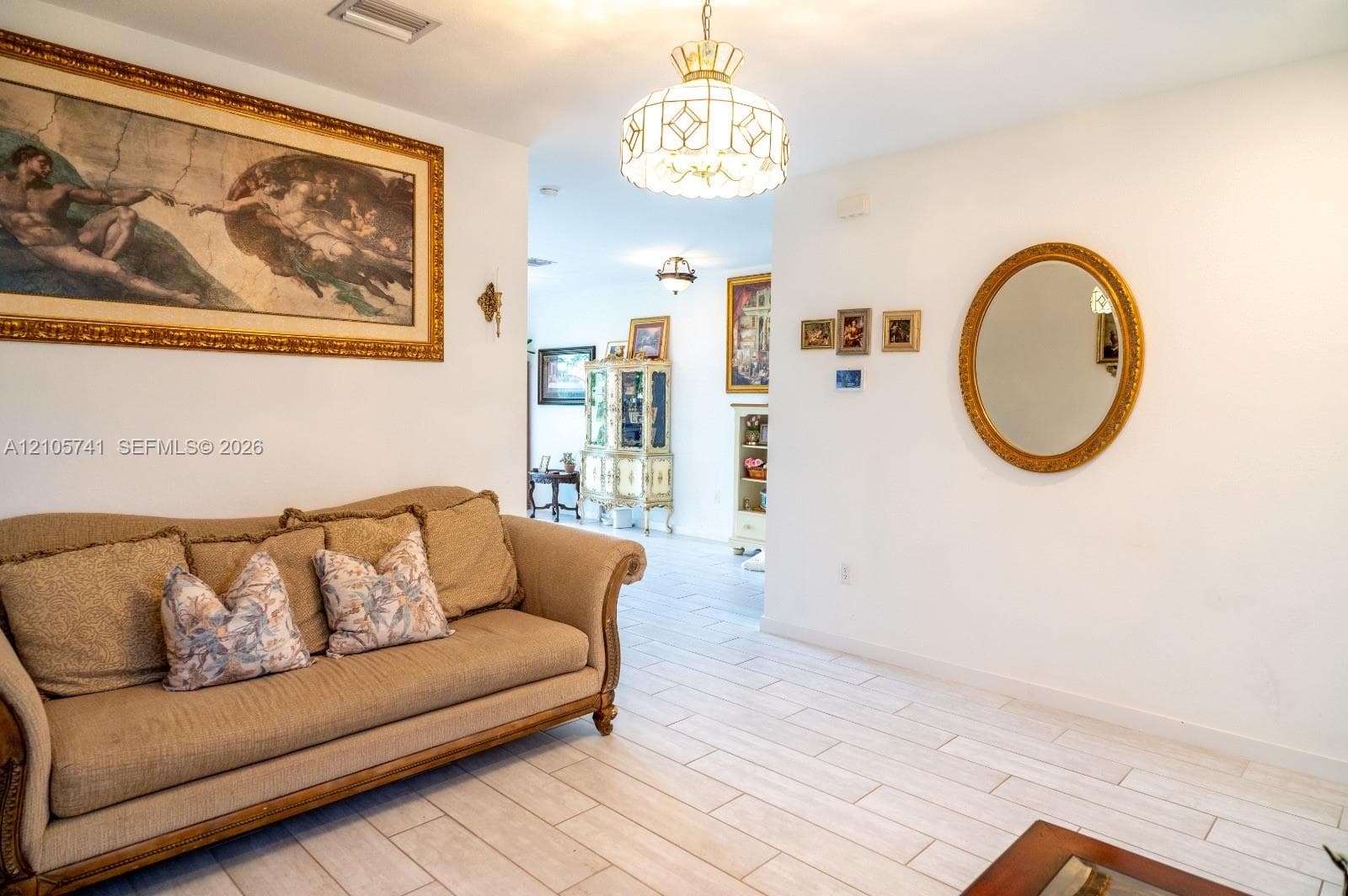 Light-toned tile flooring and decorative globe-style pendant lighting