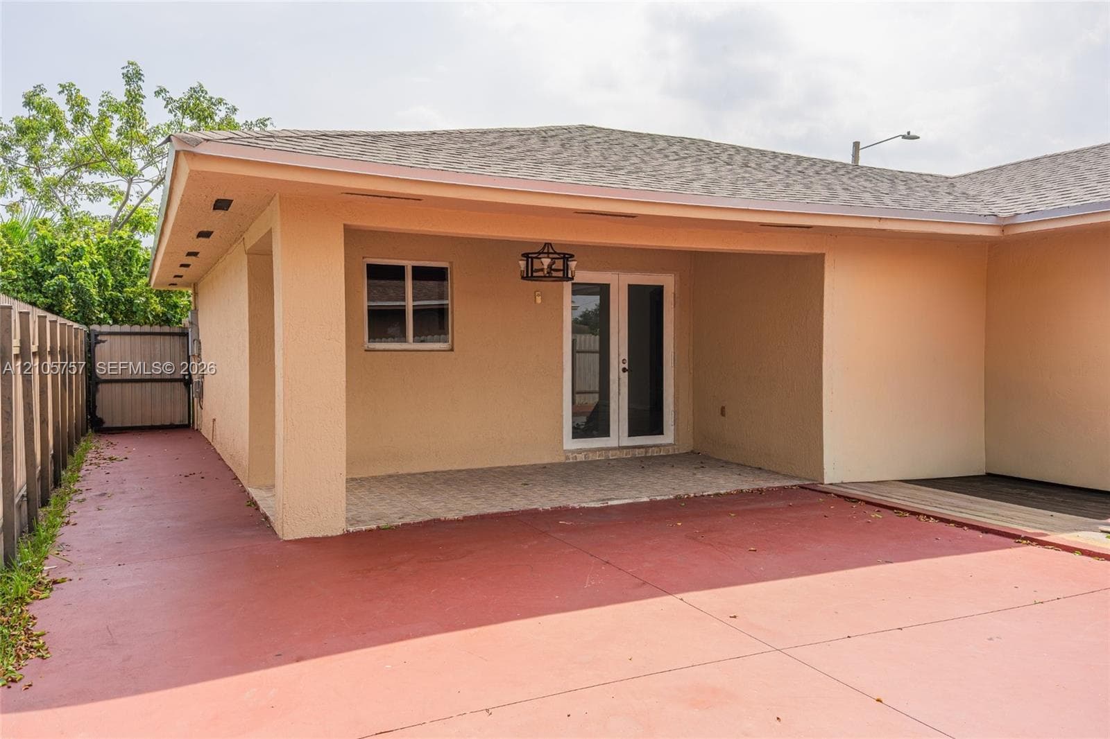 Covered patio featuring a paved surface, built-in overhead lighting, and double-door entry
