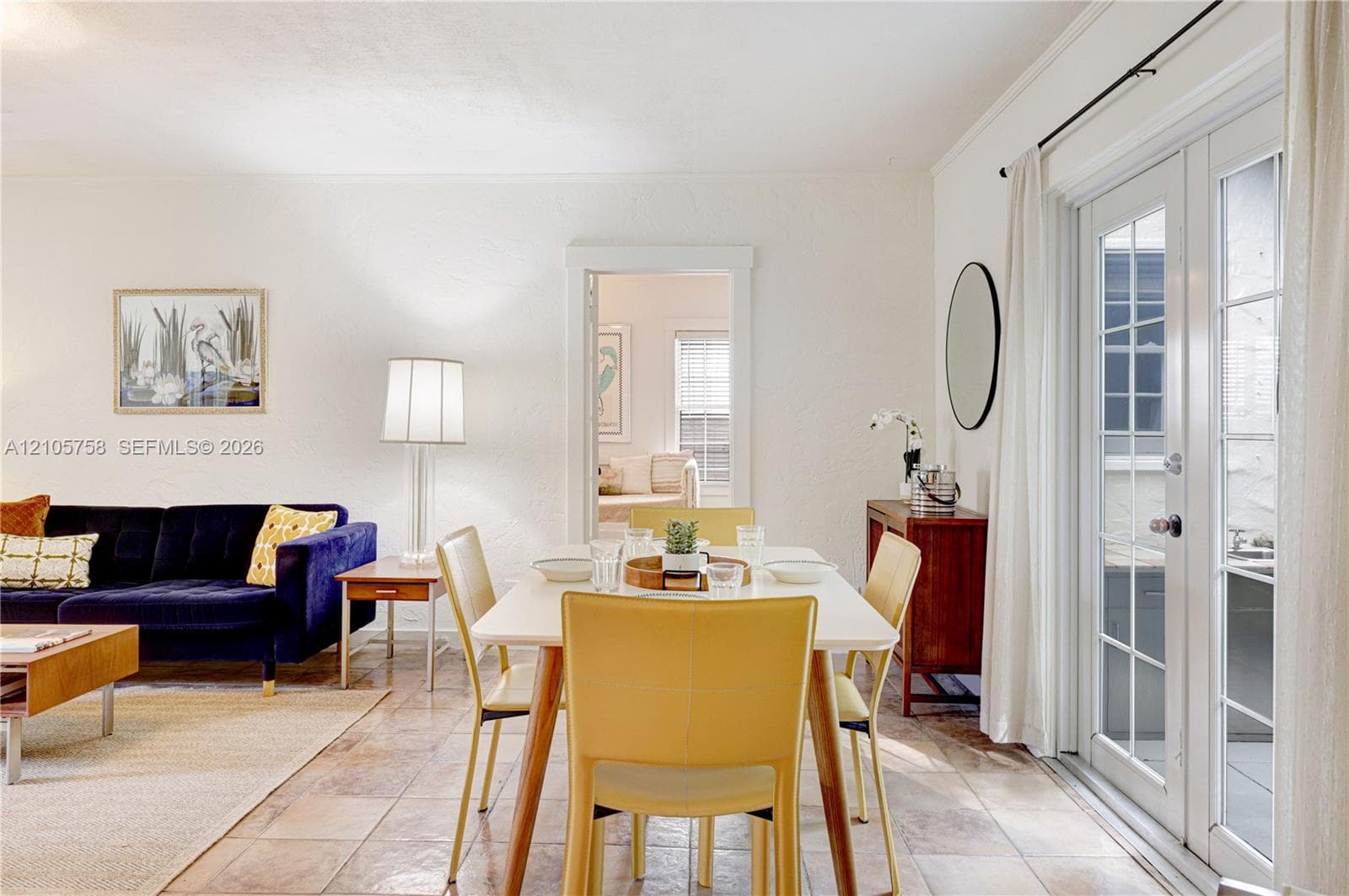 Textured wall finish, stone-tile flooring, and full-glass panel French doors