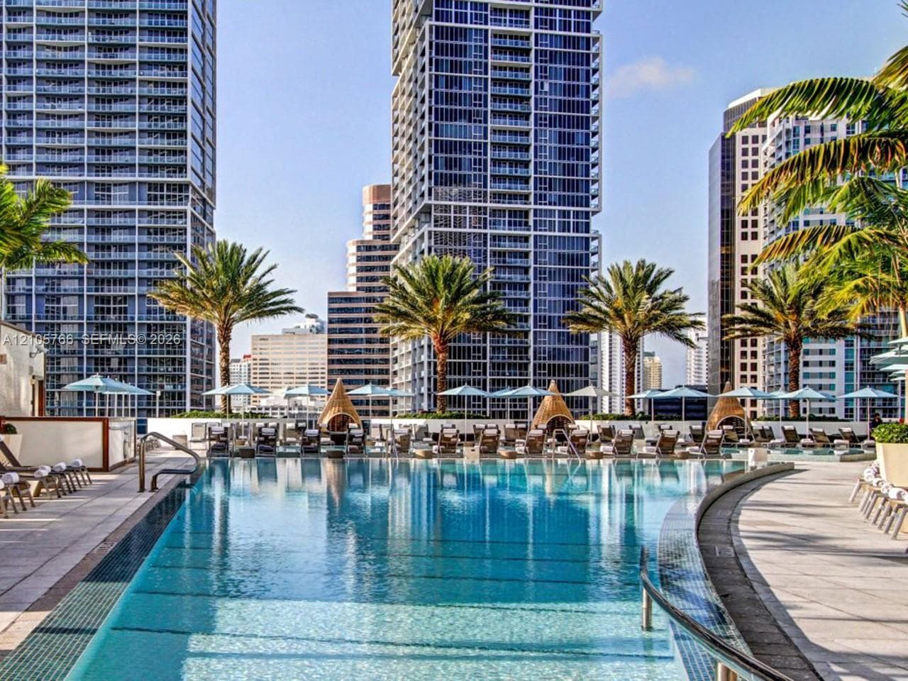 Hotel pool deck, open to residents, with city views.