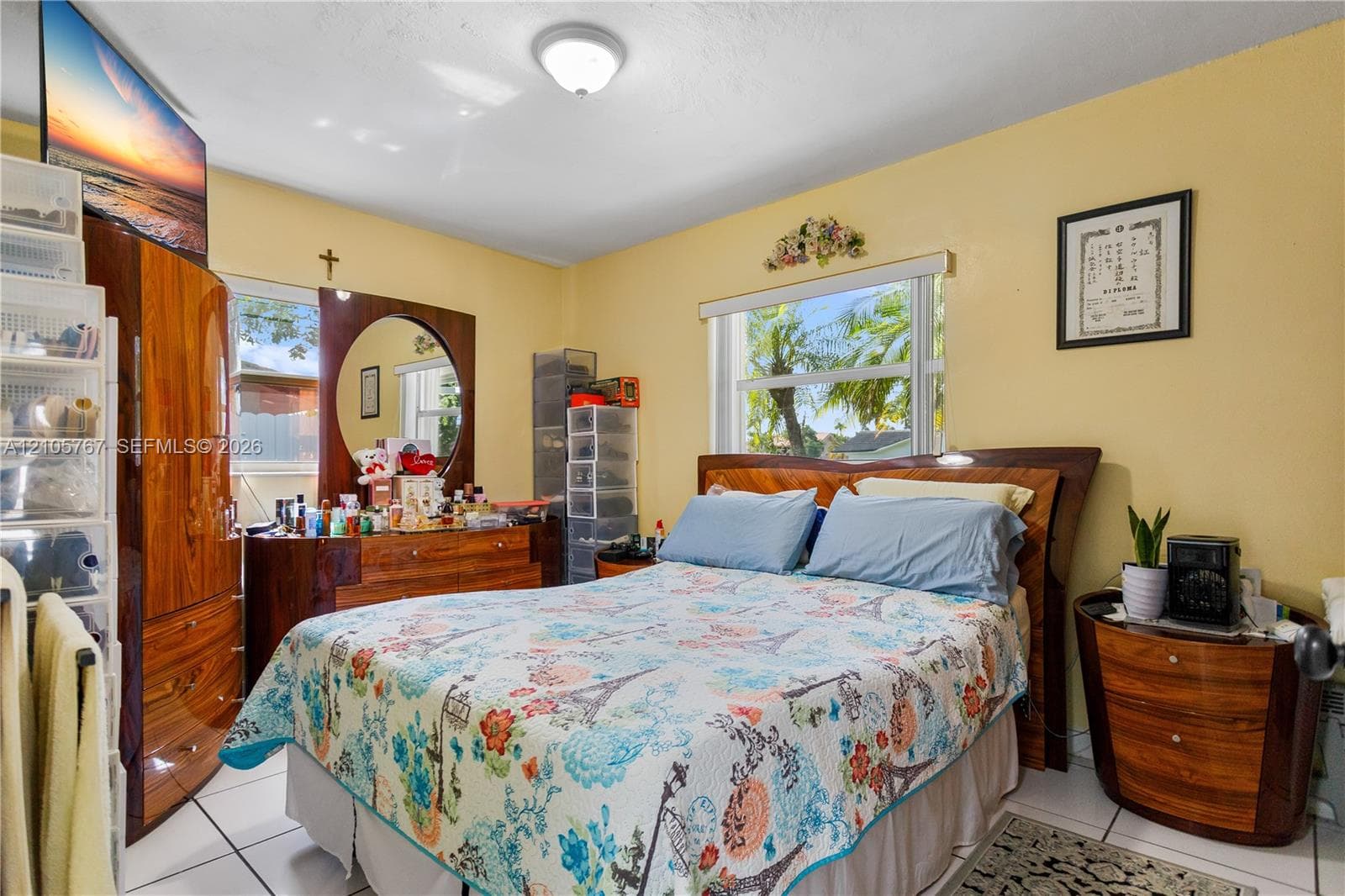 Room featuring light-toned walls, tile flooring, and two windows providing natural illumination with integrated blinds