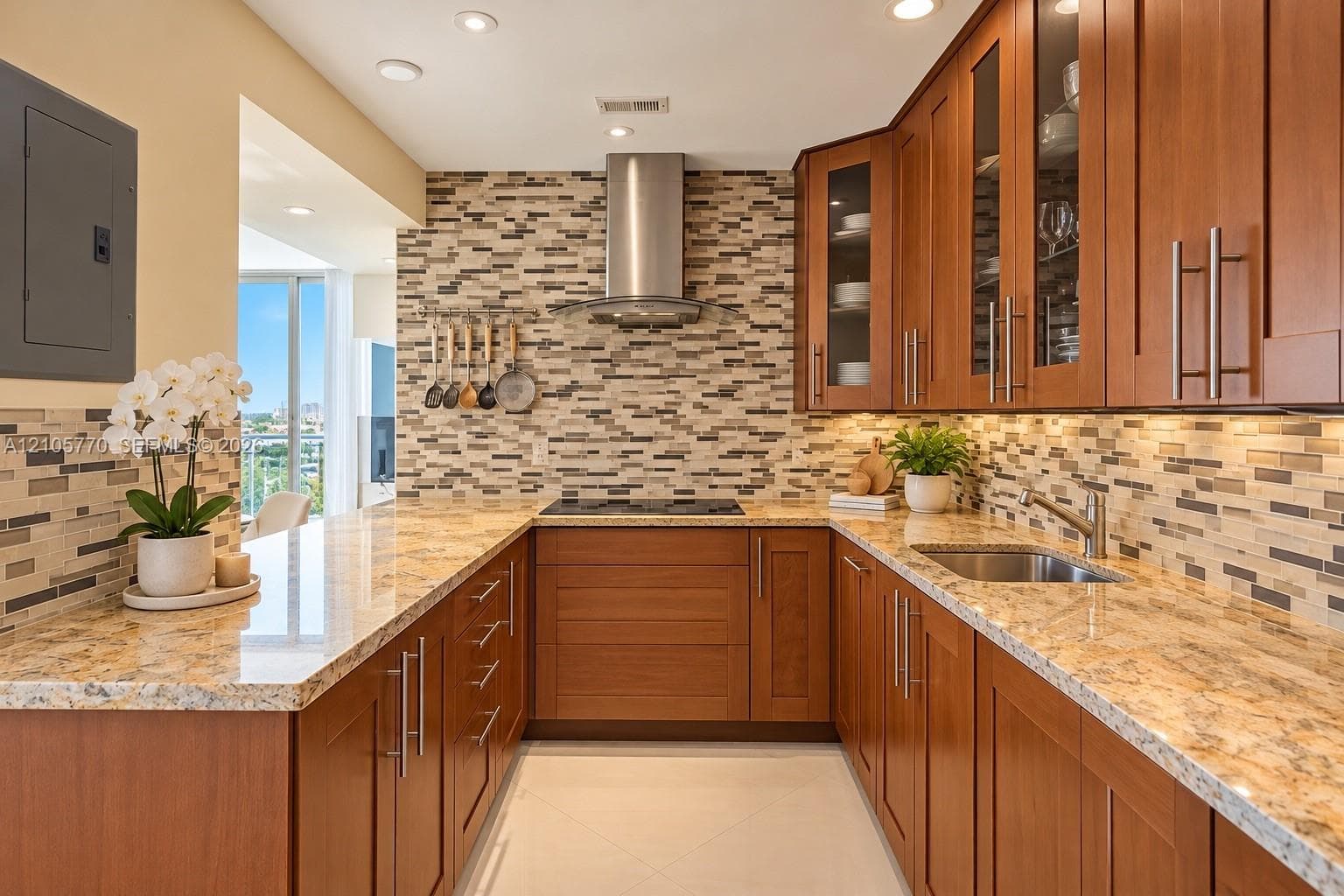 Kitchen featuring shaker-style wood cabinetry, stone countertops, a multi-tonal linear tile backsplash, stainless steel range hood, and recessed lighting
