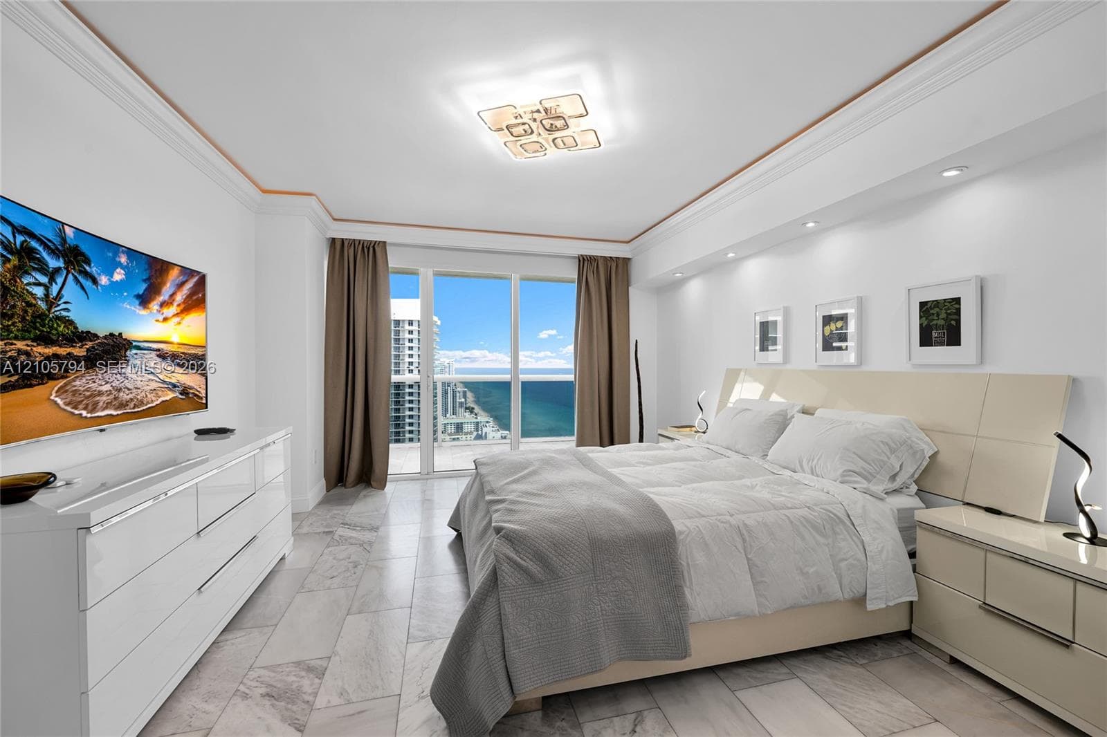 Floor-to-ceiling glass panel windows, stone-finish tile flooring, recessed ceiling lighting, decorative crown molding, and built-in soffit lighting