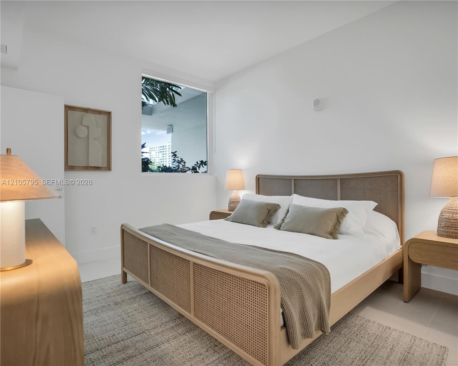Bright room featuring neutral wall finishes, large-format tile flooring, and a fixed, square-profile window