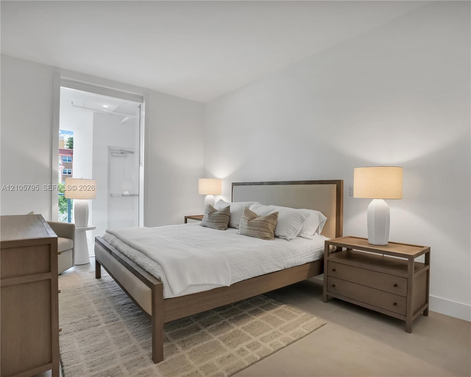 Neutral-toned interior featuring smooth wall finishes, wood-finish flooring, and a glass-paneled entry door