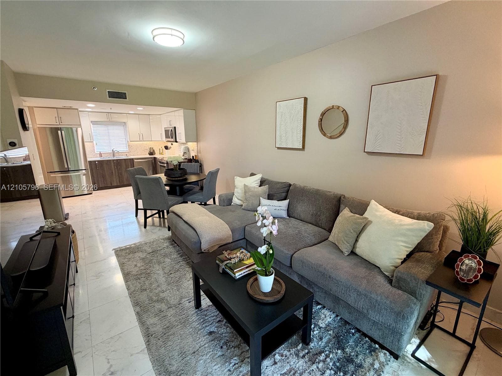Open living /dining room with marble floors