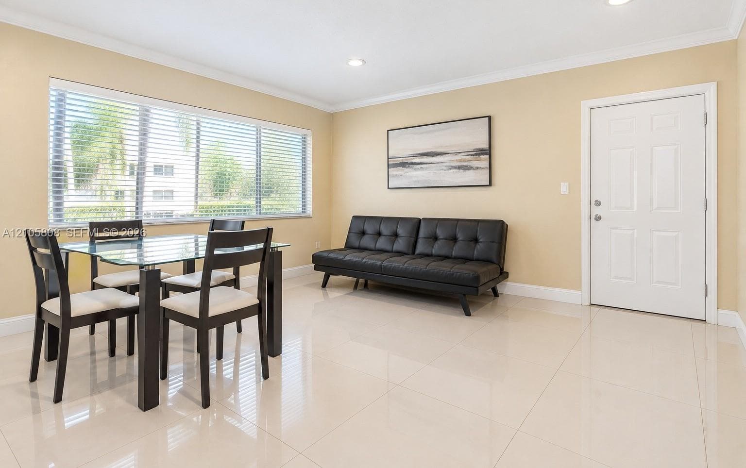 Polished tile flooring, crown molding, recessed lighting, and a large horizontal window with integrated blinds
