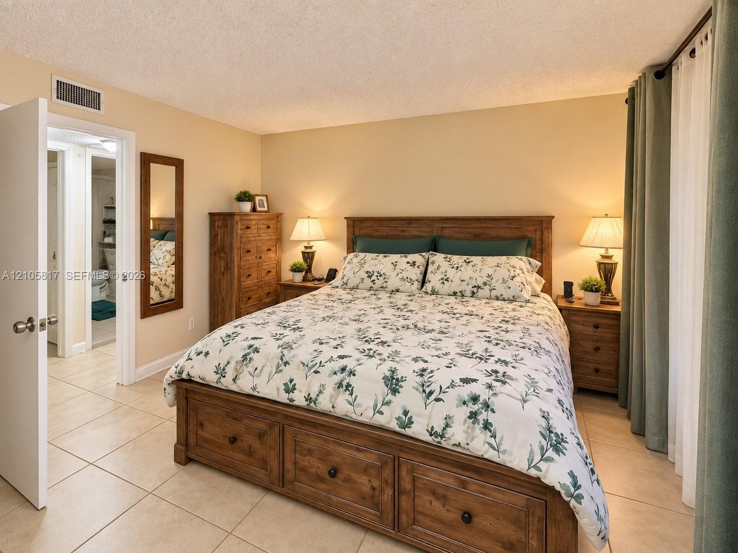 Interior space featuring large-format tile flooring, textured ceiling, and neutral wall paint