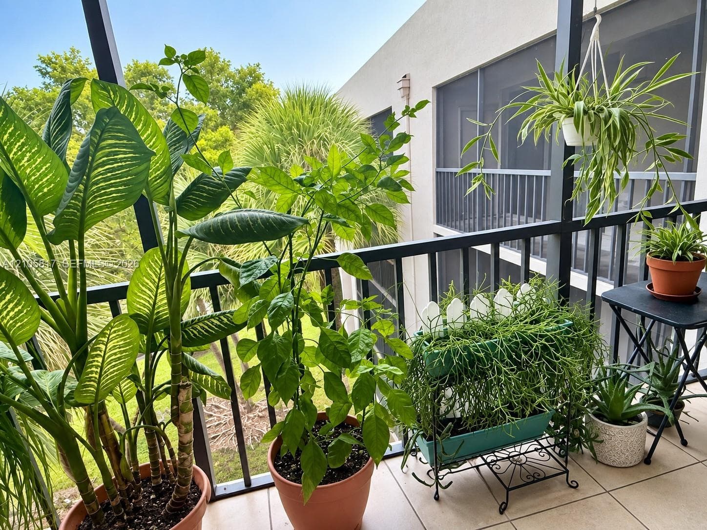 Screen-enclosed balcony featuring neutral tile flooring and dark metal railing