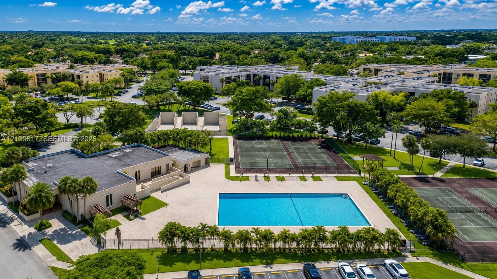 Community complex featuring an outdoor swimming pool, multiple tennis courts, a basketball court, and manicured landscaping