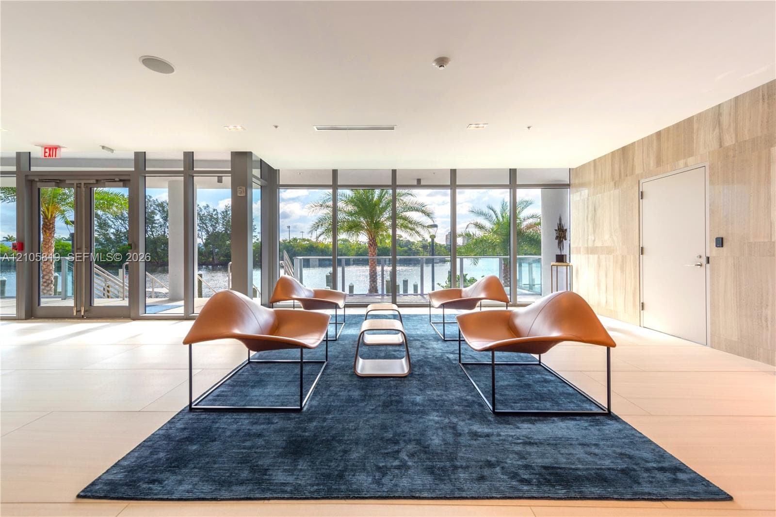 Waterfront Lobby.  Floor-to-ceiling glass paneling, tile flooring, natural stone wall finish, and exterior water access