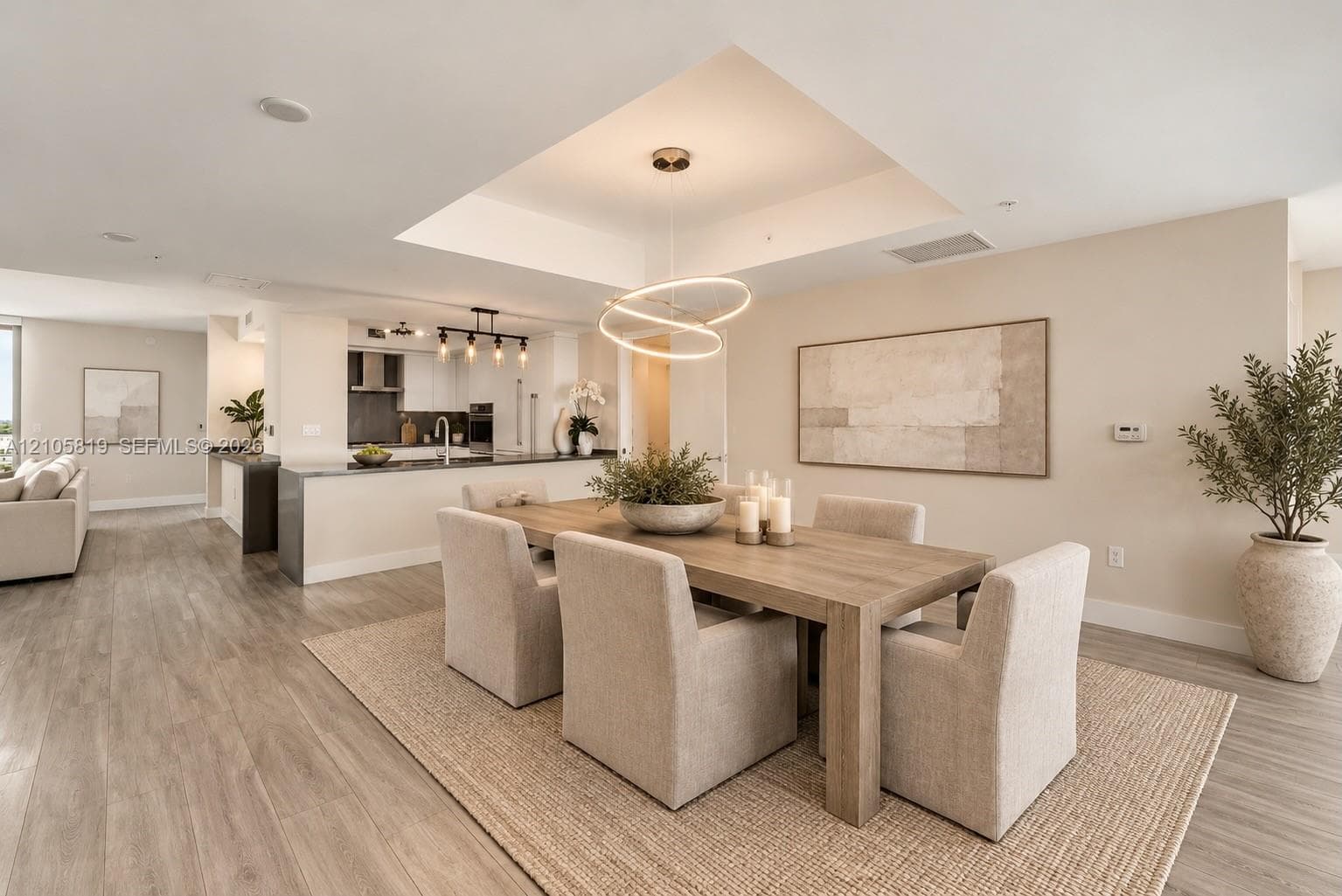 Open-concept Dining Room featuring a tray ceiling.