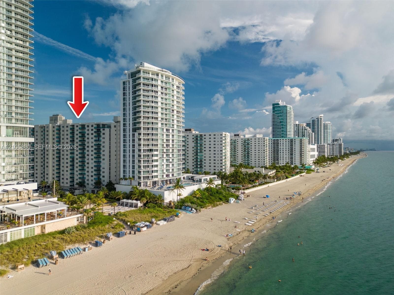 High-rise building exterior featuring private balconies and proximity to the shoreline