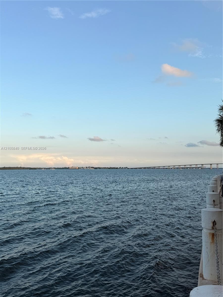 Waterfront exposure featuring a concrete seawall with chain railing