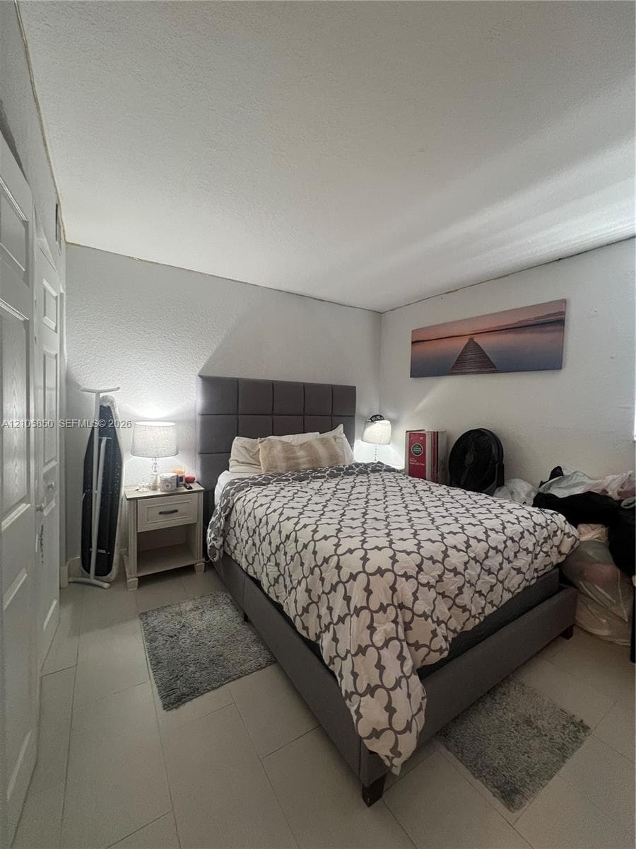 Neutral-toned tile flooring and double-panel doors