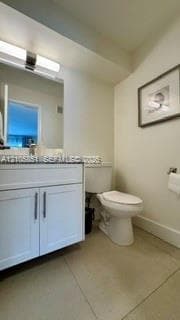 Bathroom featuring a white vanity cabinet with a solid surface countertop, rectangular under-mount sink, polished chrome faucet, and integrated linear vanity lighting