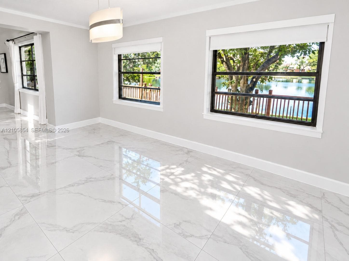 Edited image showing how the room would look without furniture, highlighting its spacious layout, beautiful flooring and stunning lake view.