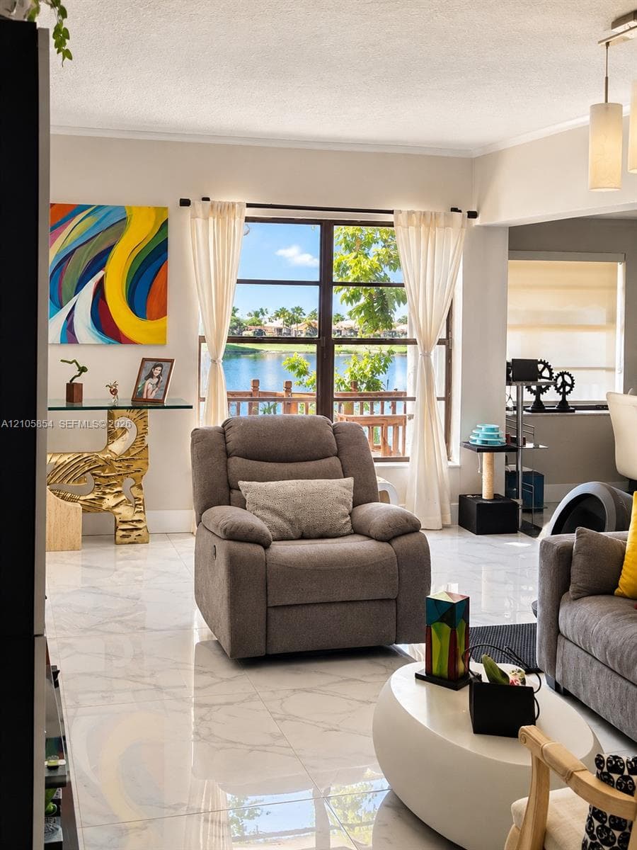 Large picture window featuring water scenery, polished stone-finish tile flooring, and a multi-pendant ceiling light fixture