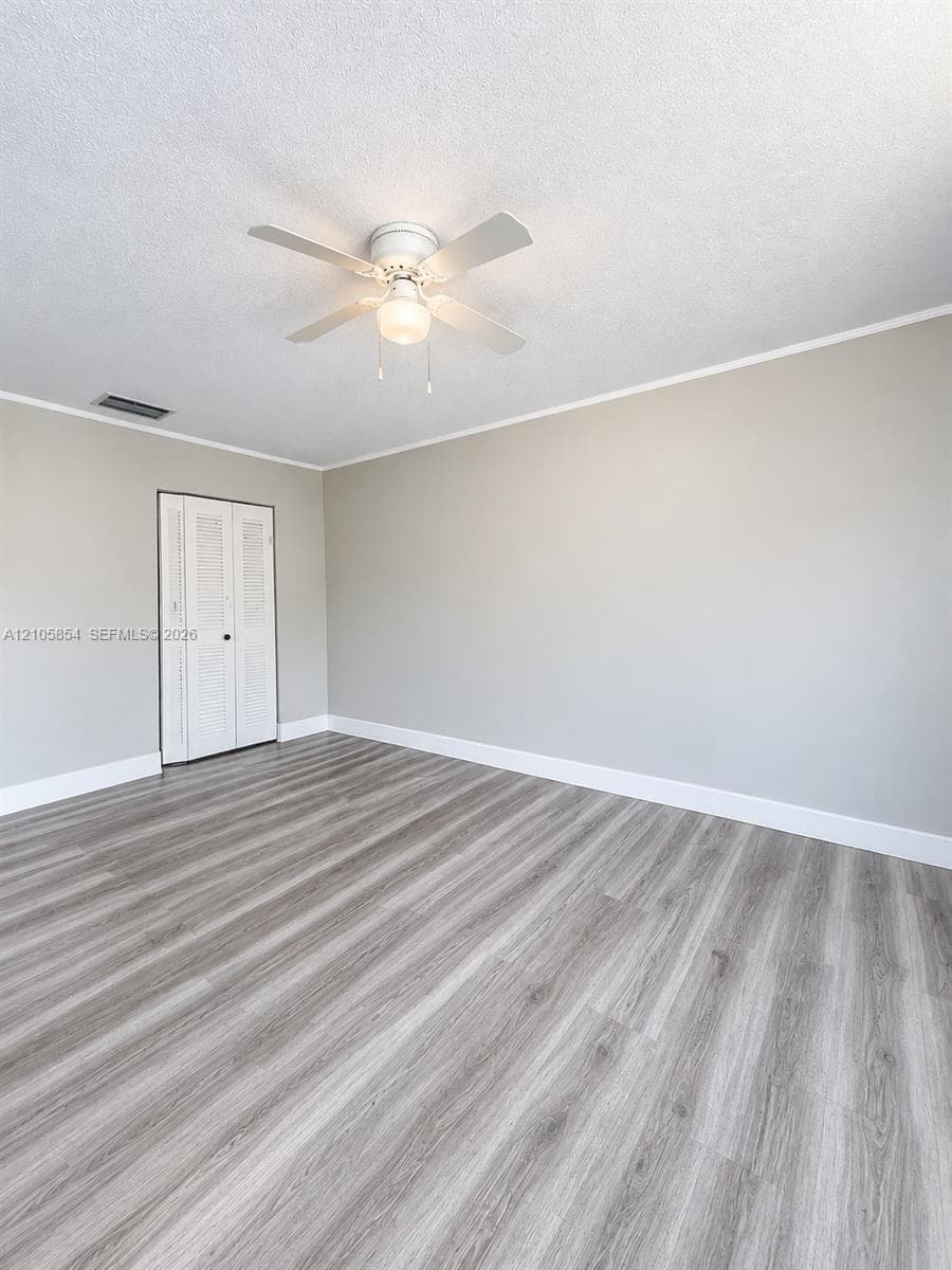 Edited image showing how the room would look without furniture, highlighting its spacious layout and beautiful flooring