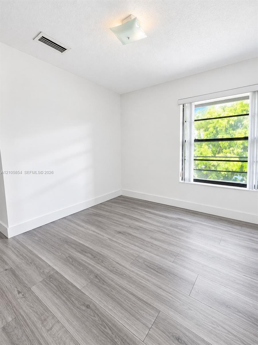 Edited image showing how the room would look without furniture, highlighting its spacious layout, beautiful flooring and stunning lake view.