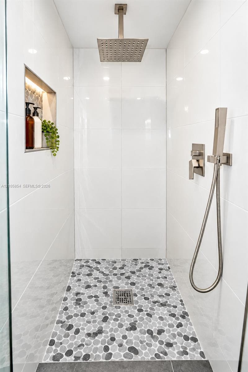A first floor full bathroom next to a bedroom provide flexibility for guests, family, or a home office