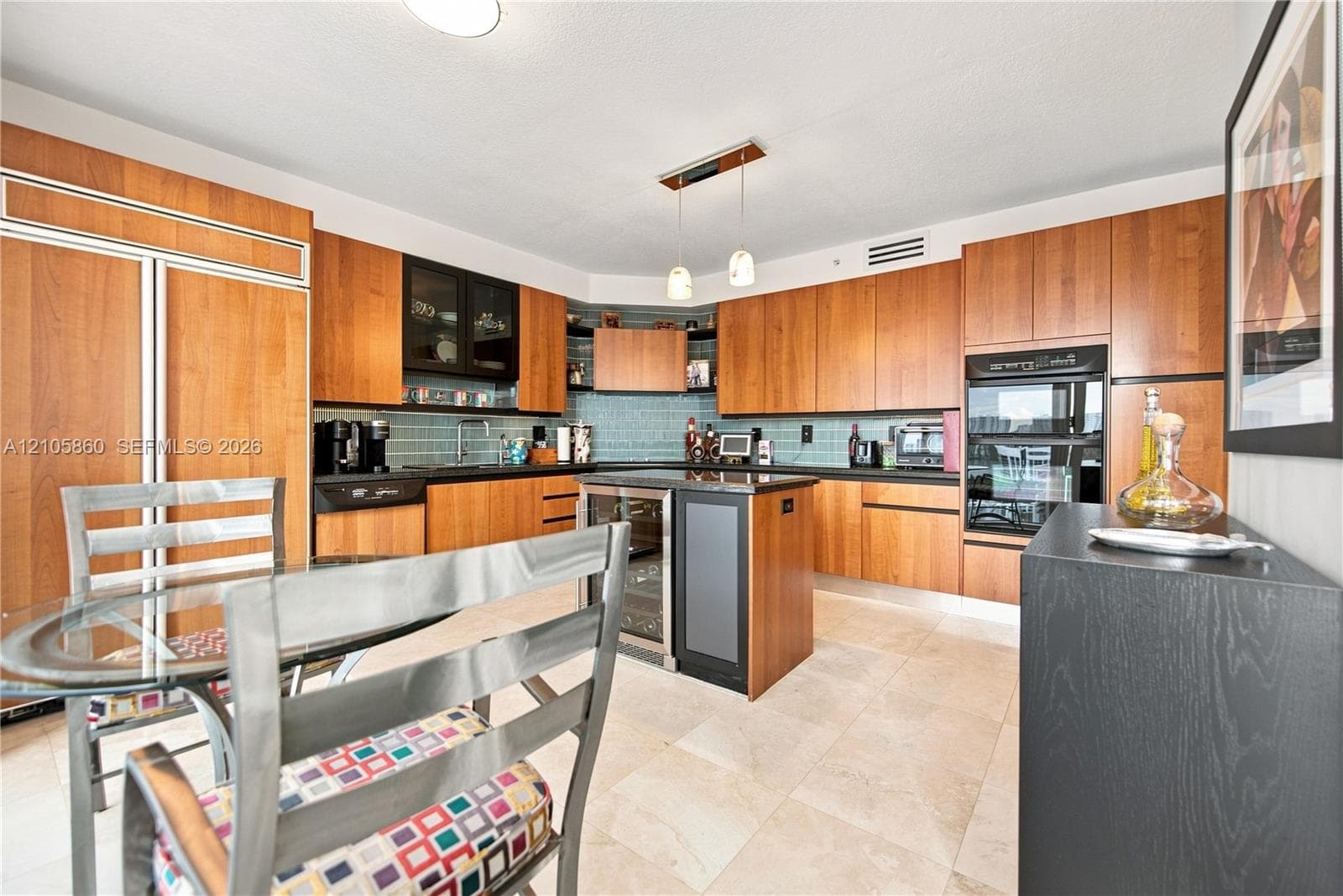 Kitchen featuring flat-panel wood cabinetry, stone countertops, tiled backsplash, center island with built-in wine refrigeration, and stainless steel wall-mounted oven