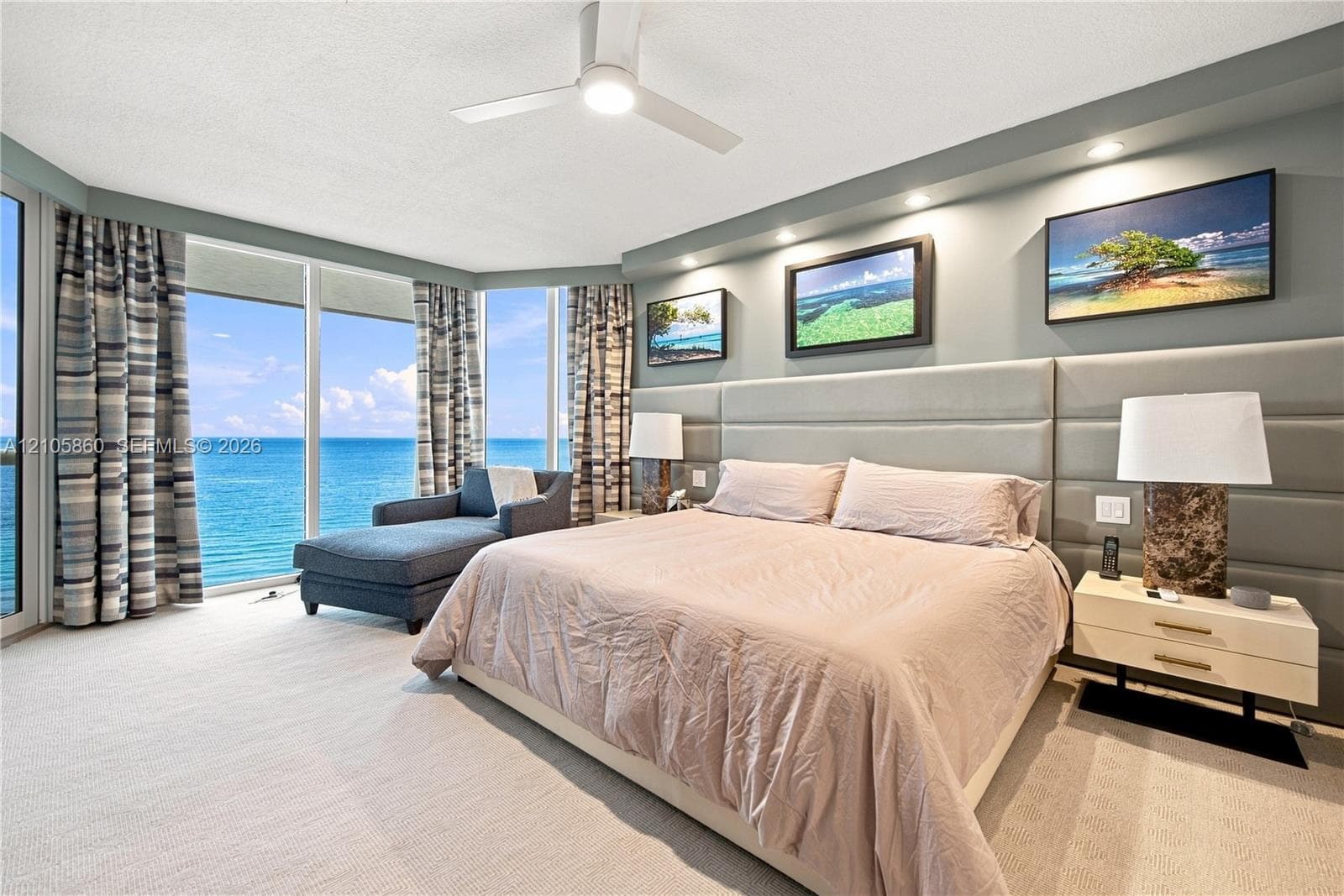 Floor-to-ceiling windows, custom padded wall paneling, recessed lighting, ceiling fan, and wall-to-wall carpeting