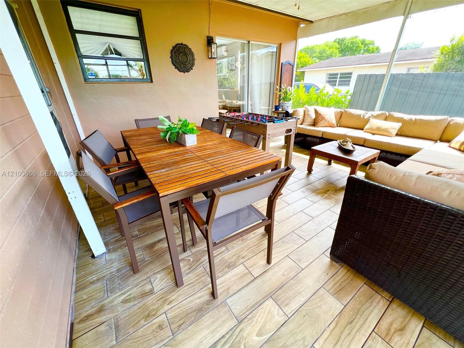 Main House's Screened-in patio featuring wood-finish tile flooring, recessed ceiling lighting, and sliding glass door access