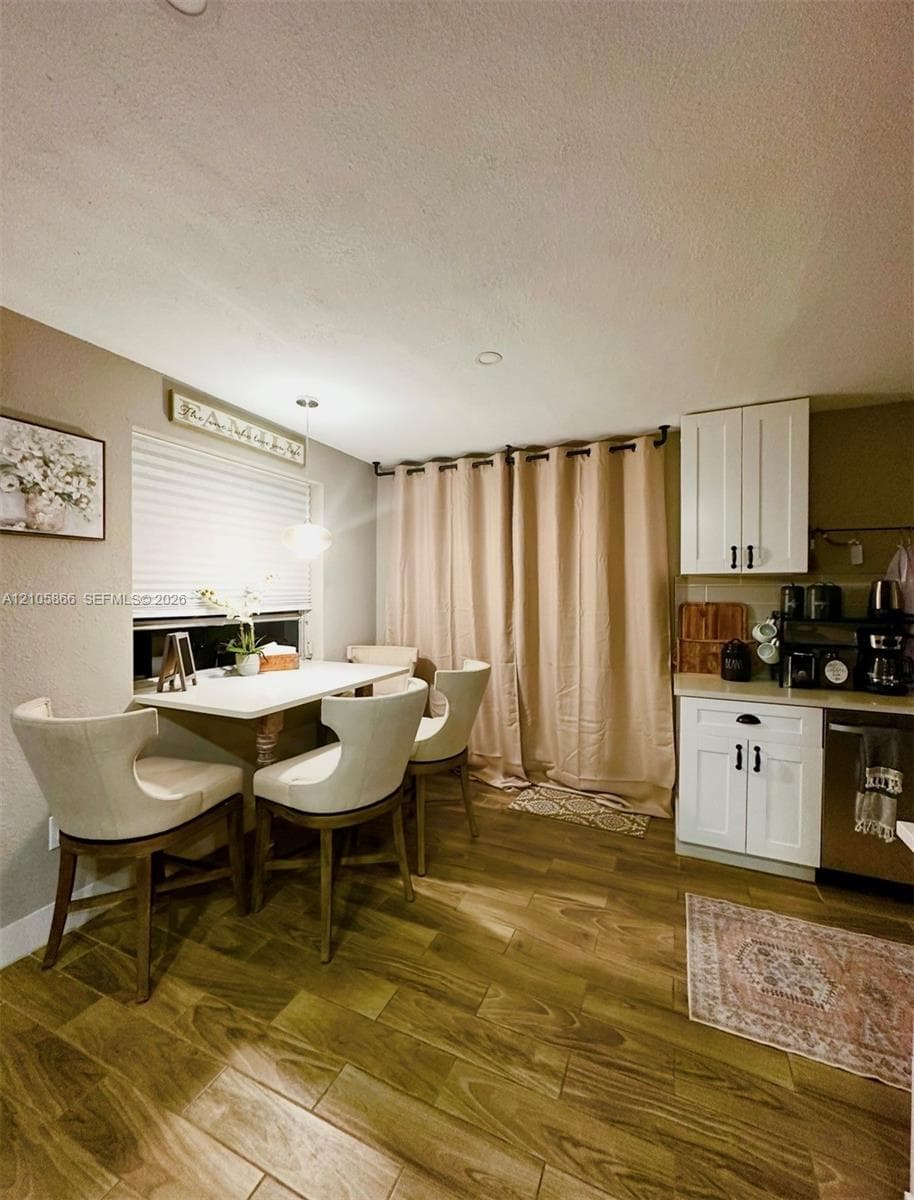 White cabinetry with matte black hardware,Main House wood-finish flooring, and recessed ceiling lighting