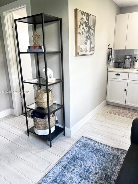 1/1 area White solid-surface countertop with wood-finish flooring and a central ceiling fan