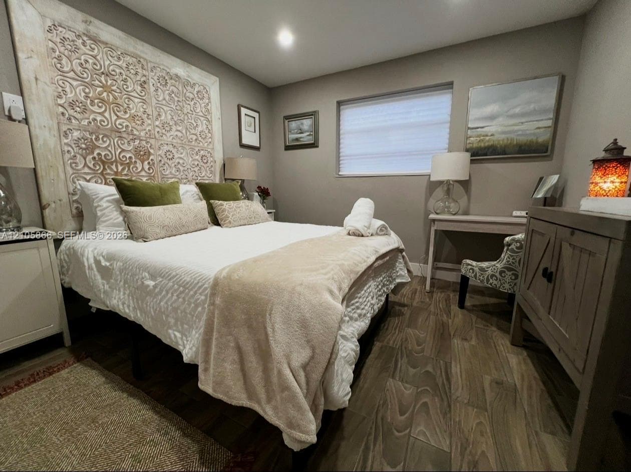 main house br 1 Wood-finish tile flooring, recessed lighting, and a large decorative wall-mounted architectural panel