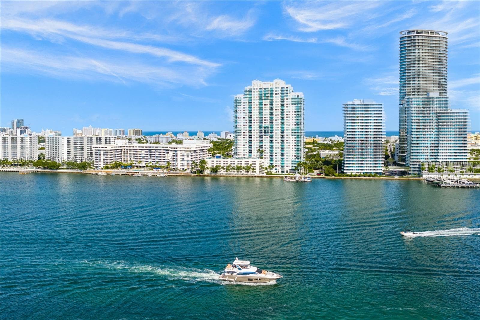 Waterfront perspective featuring high-rise towers, marine channel, and coastal horizon