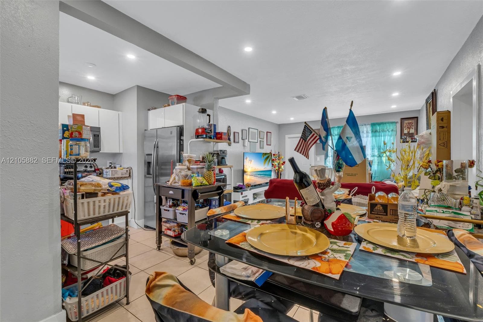 Open-concept interior featuring recessed lighting, ceramic tile flooring, and white flat-panel cabinetry