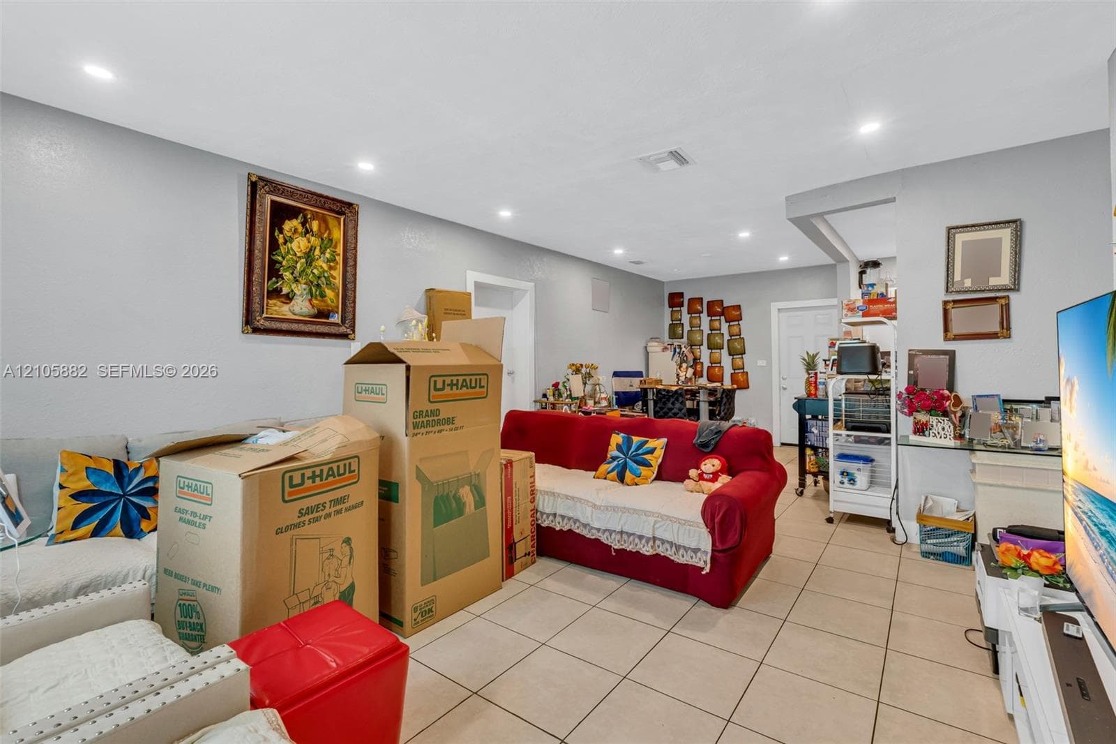 Neutral-toned interior space featuring light-colored ceramic tile flooring and recessed lighting