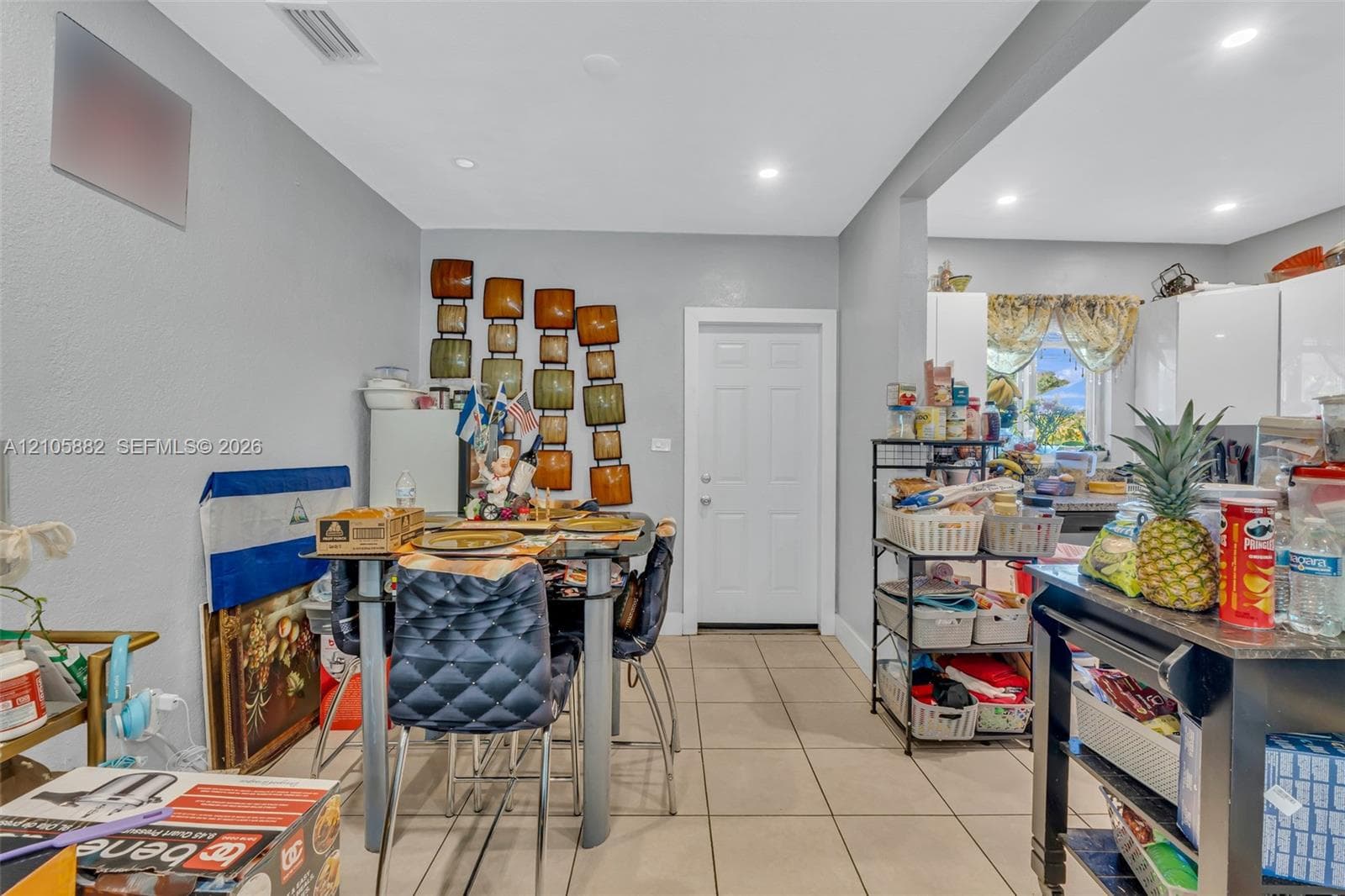 Ceramic tile flooring, recessed lighting, and white interior door