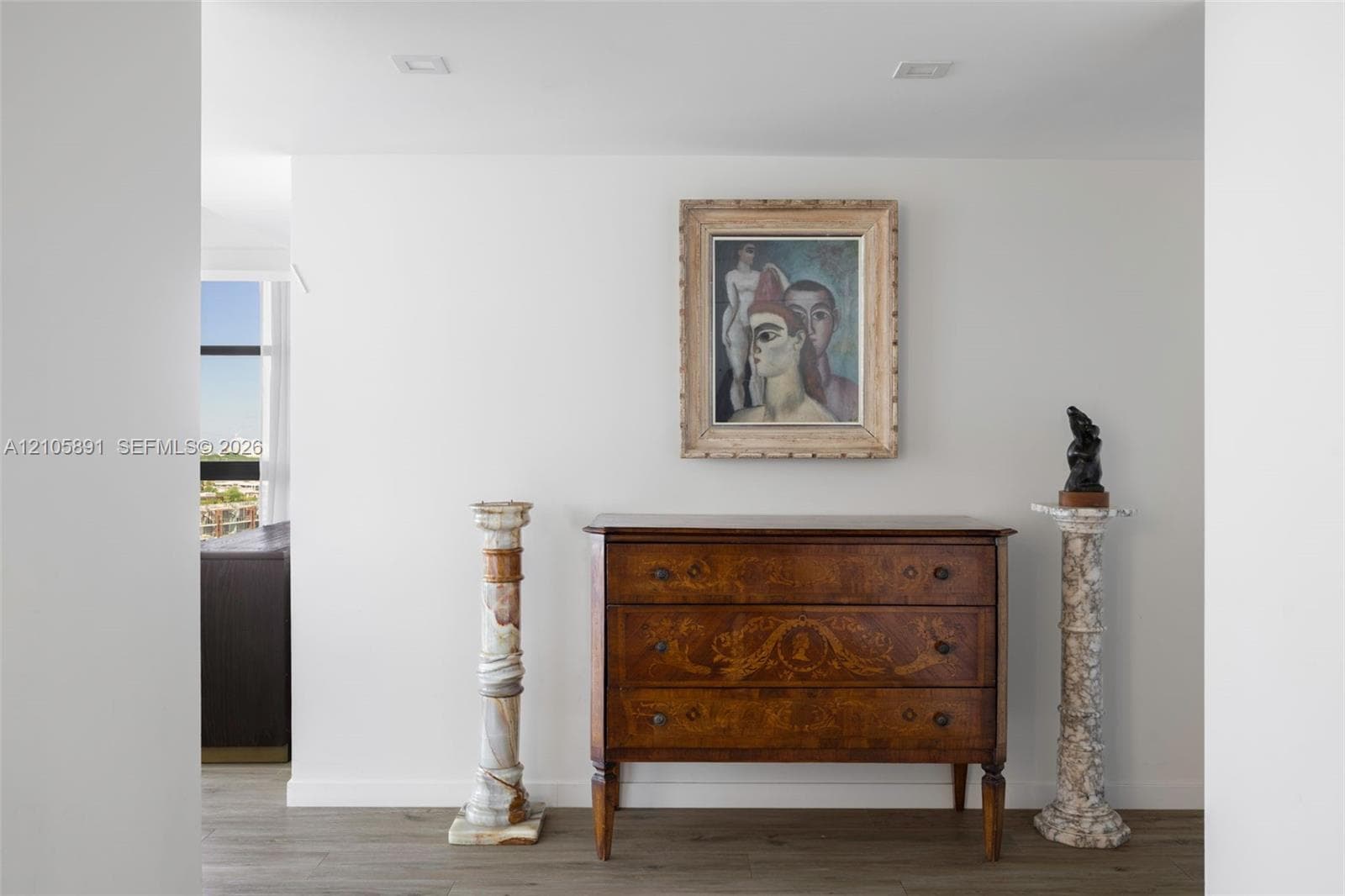 Neutral-toned walls and wood-finish flooring with recessed ceiling lighting