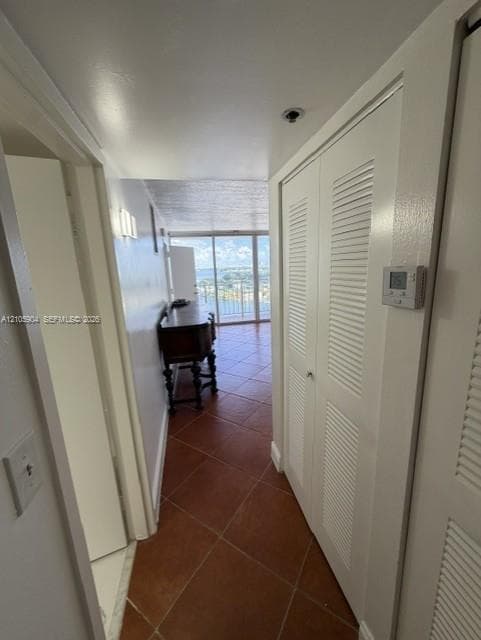 Tile flooring throughout and floor-to-ceiling glass sliding doors