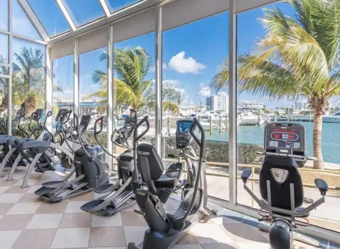 Floor-to-ceiling glass walls, expansive skylights, tile flooring, and direct maritime proximity