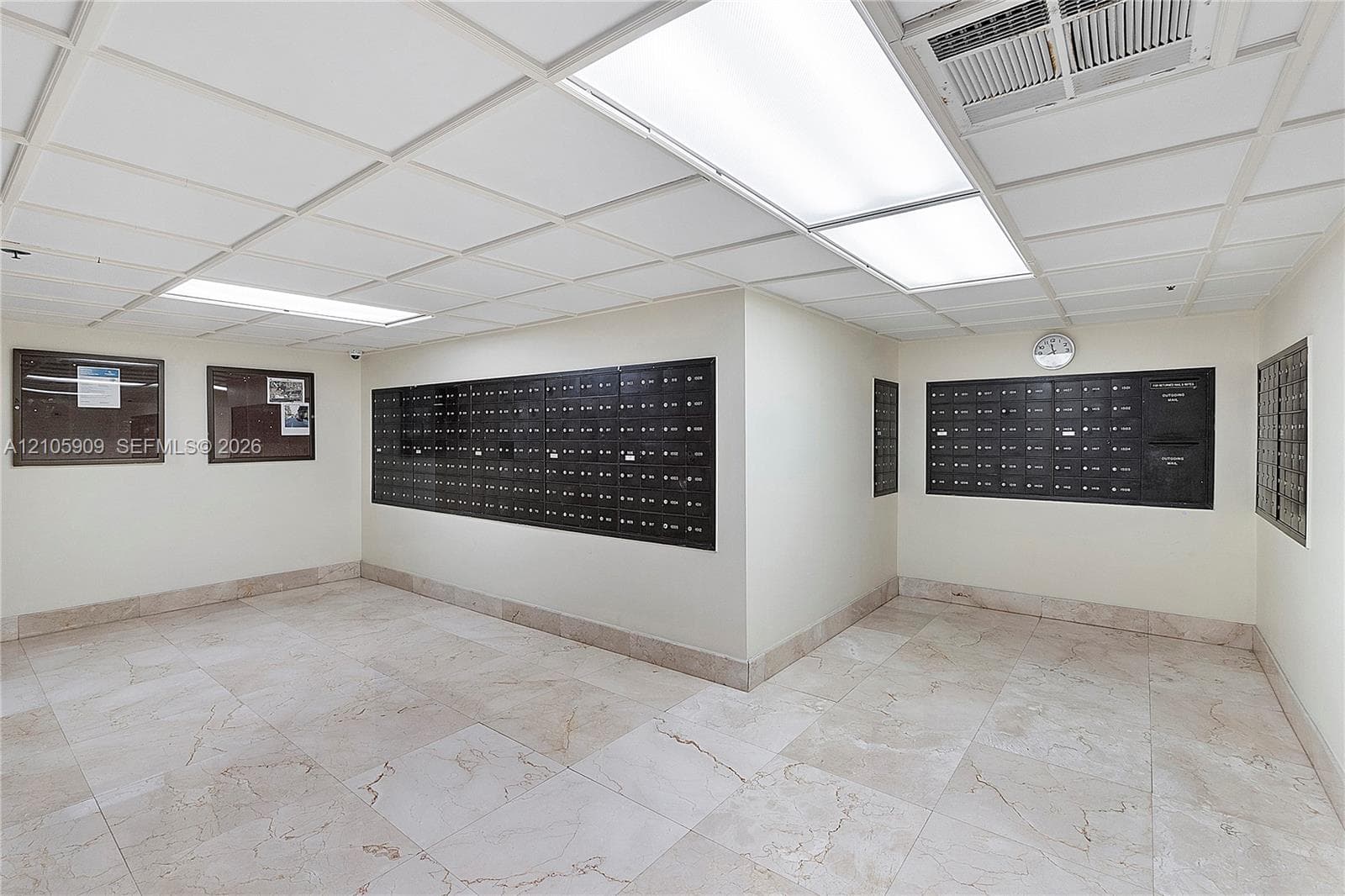 Mailroom featuring recessed lighting, tiled flooring, and wall-mounted metal mailbox units