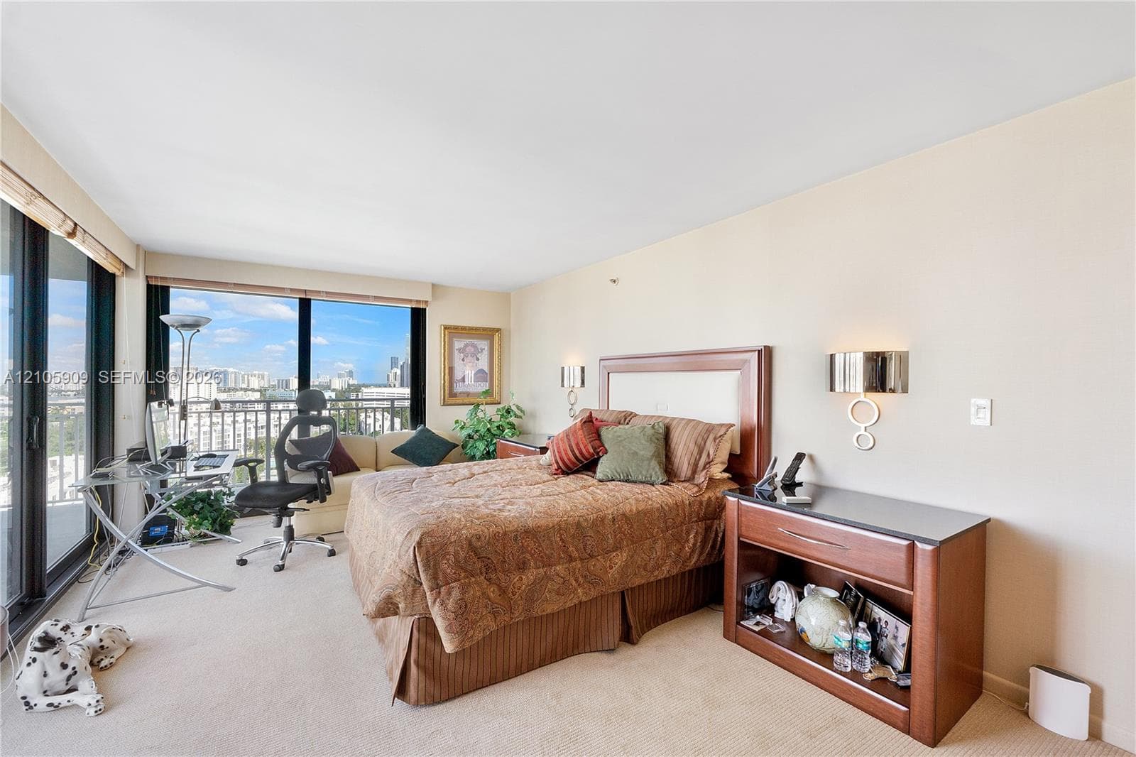Floor-to-ceiling windows, wall-mounted light fixtures, and wall-to-wall carpeting