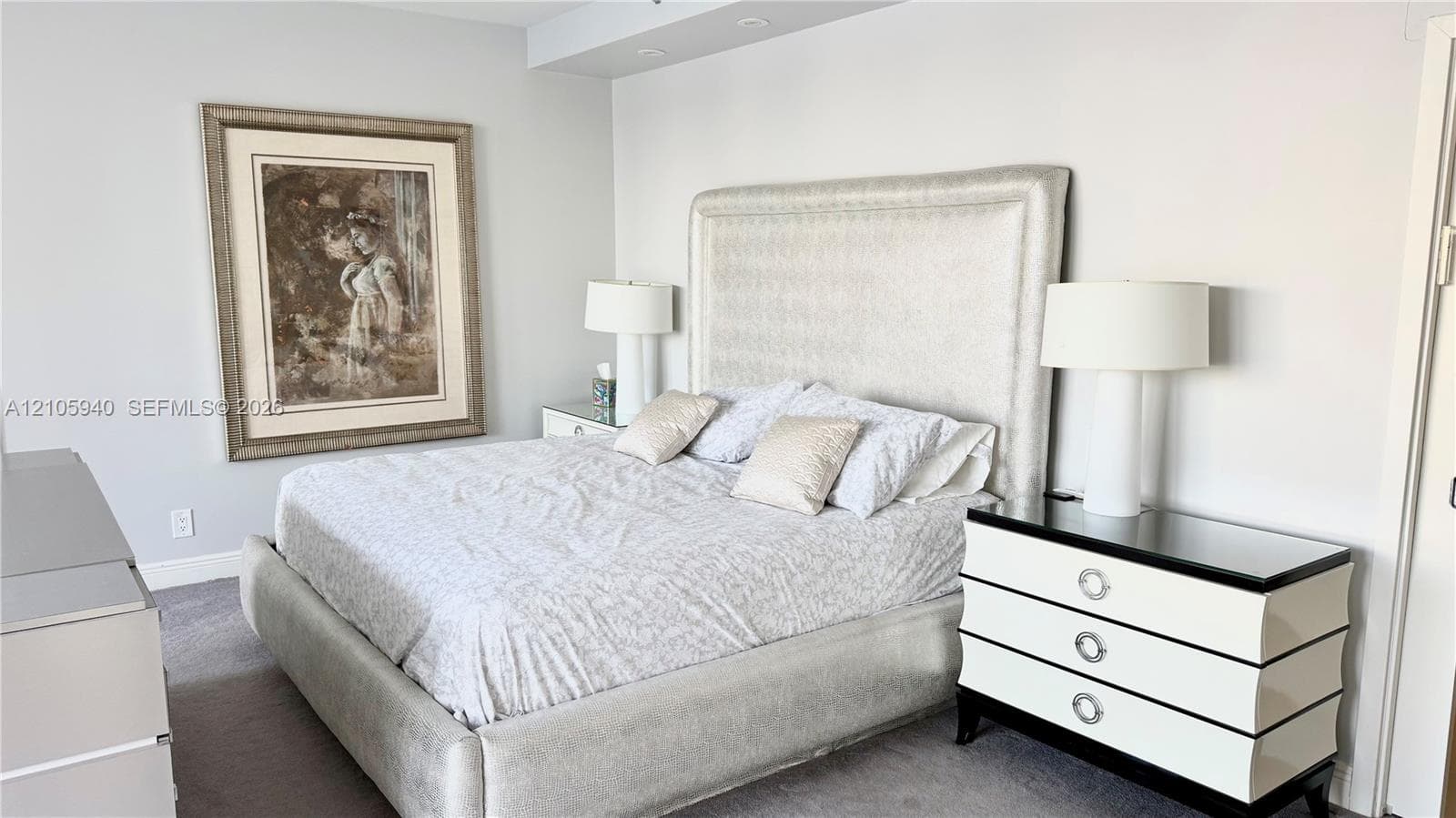 Neutral wall palette with soft gray carpeting and recessed ceiling lighting